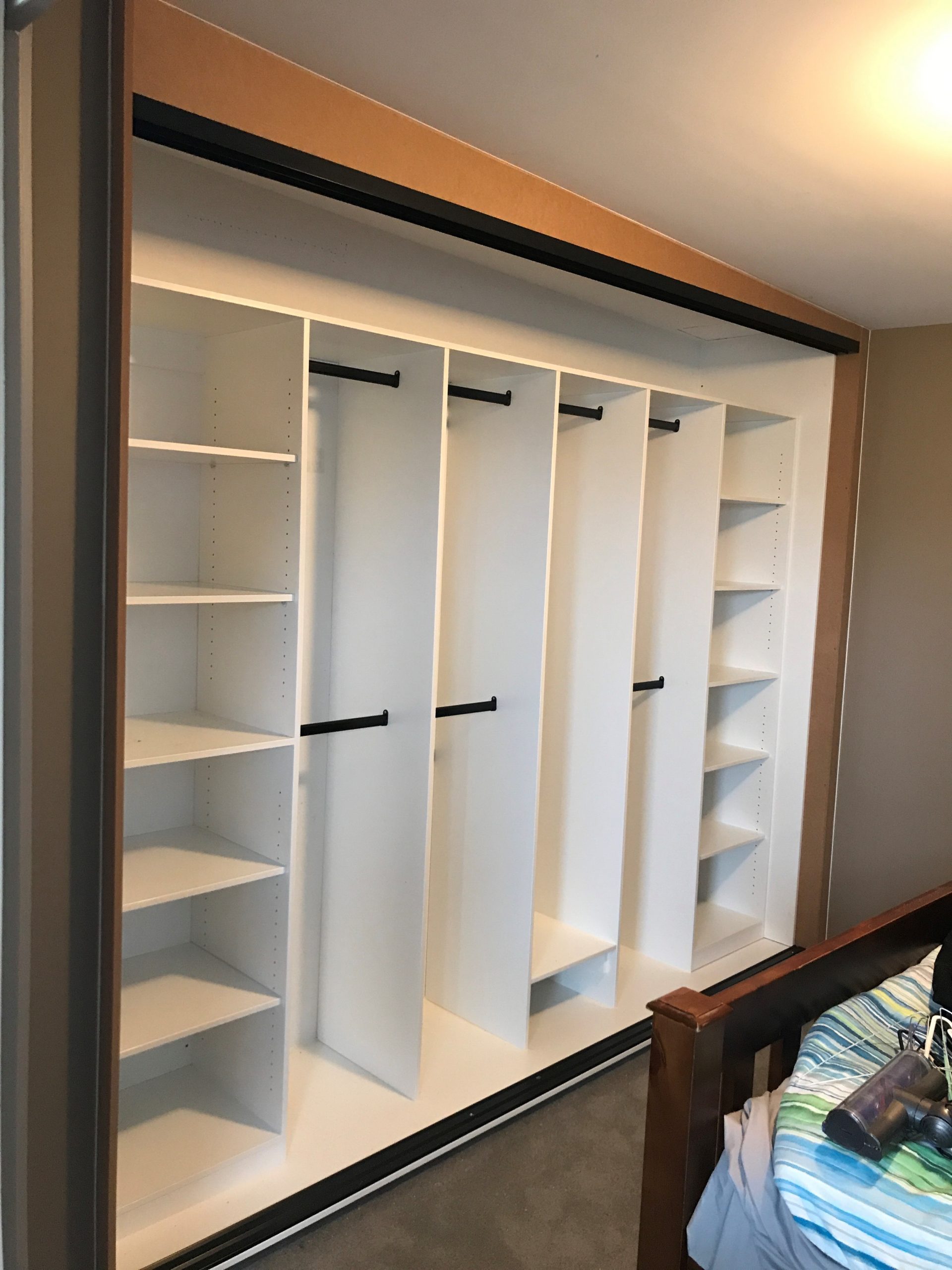 Custom built in robe, adjustable shelving and hanging space with black hanging rods in Williamstown