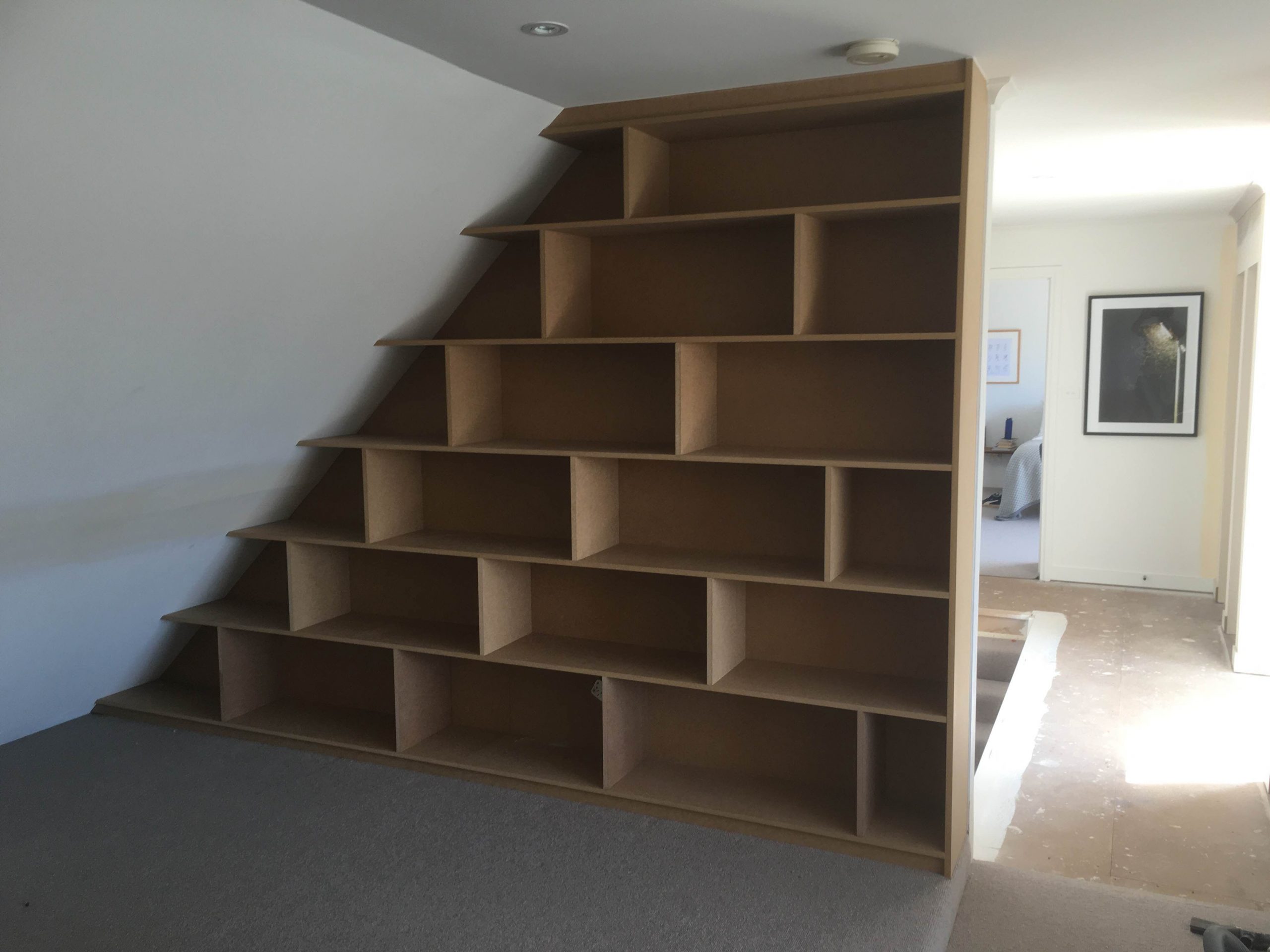 bookshelf under stairs