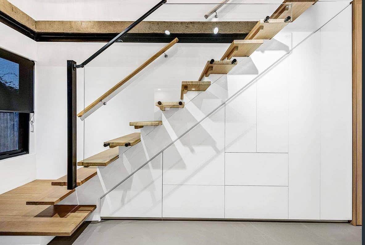 wardrobe solutions - modern white under stair storage cupboards with timber staircase